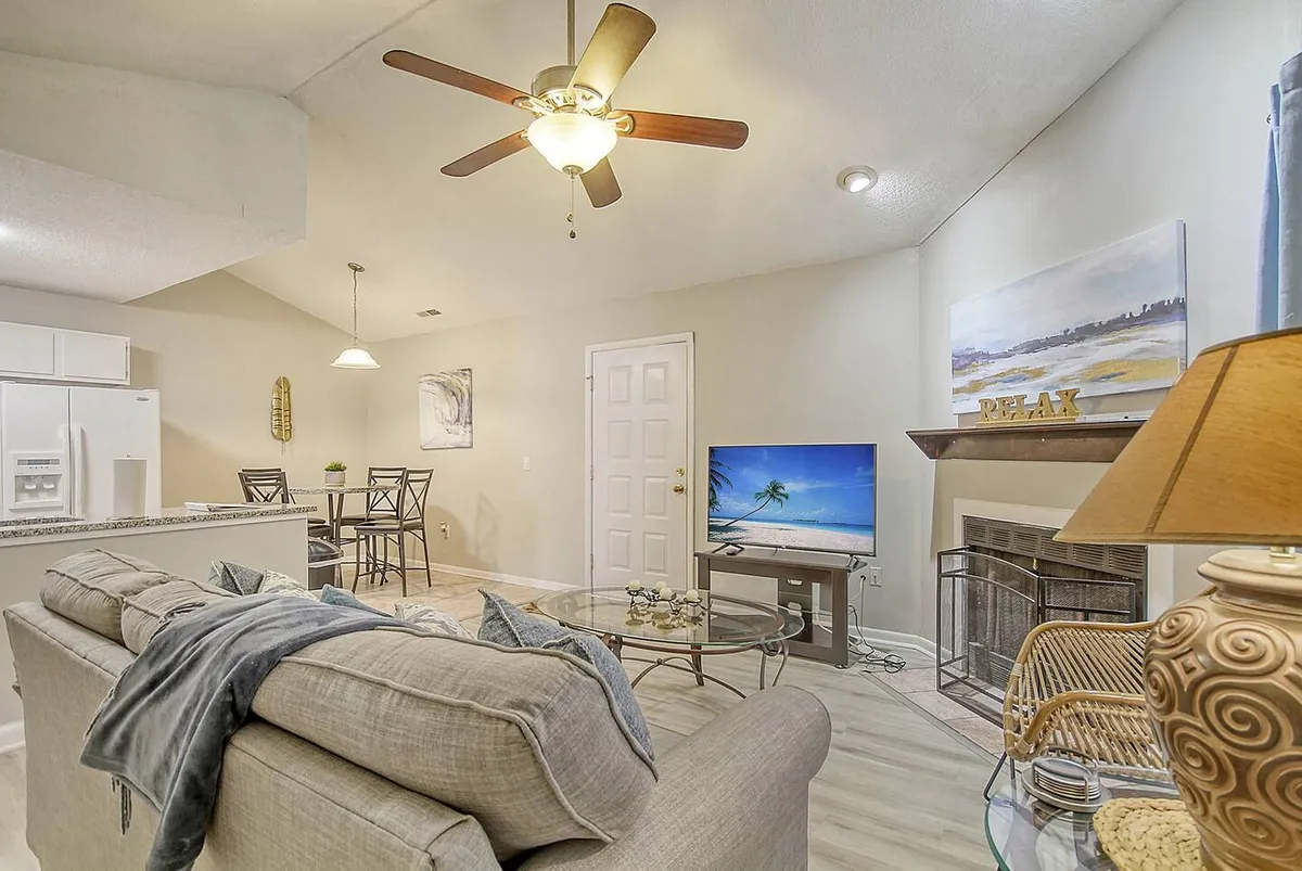 A cozy living area with a plush sofa, television, and dining table set for casual meals or game nights. The space feels inviting and functional, perfect for families to relax after days spent at nearby parks or attractions.